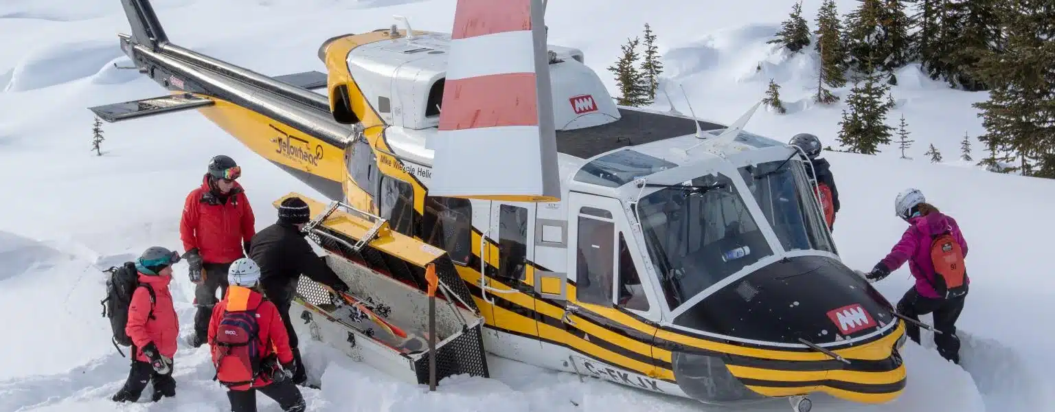 Bell 212 helicopter landed at heli-skiing drop-off site