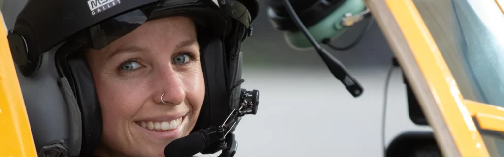 Search for the next generation 9 Photo of smiling low-time pilot Sofie at the helicopter controls