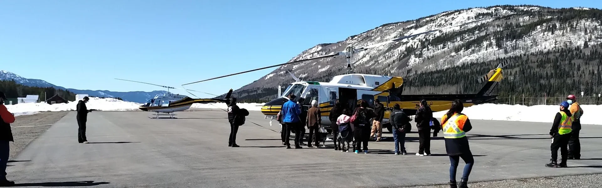 Photo of helicopters picking up Talhtan passengers at Dease Lake BC airport