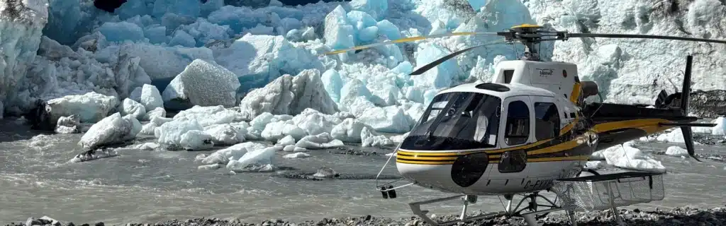 Keith Varga at Careers in Aviation Expo 1 AS350 helicopter landed in front of crumbling glacier